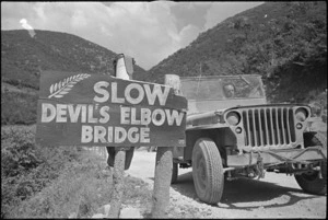 Warning sign on hilly road used by 2 NZ Division personnel in Cassino area, Italy, World War II - Photograph taken by George Kaye