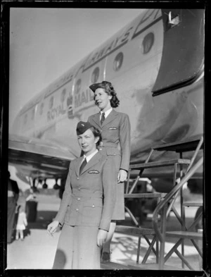 [Miss?] Pat Manton (front) and [Miss?] Helen Somerville (behind), stewardesses for ANA (Australian National Airways), standing in front of passenger aircraft Douglas DC-4 Skymaster Amana