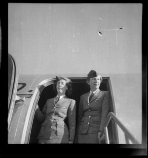 [Miss?] Helen Somerville (left) and [Miss?] Pat Manton, stewardesses for ANA (Australian National Airways), standing in front of doorway of passenger aircraft Douglas DC-4 Skymaster Amana
