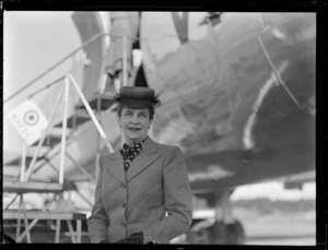 Mrs G Bassant, in front of passenger aircraft Douglas DC-4 Skymaster Amana, RNZAF Station, Whenuapai, Auckland
