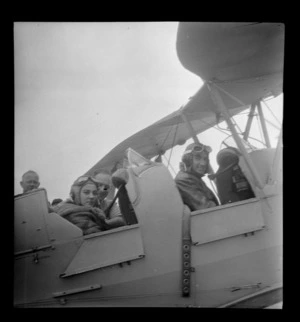Portrait of Mr K Robinson and Miss Henny Van Polanan Petel in a Tiger Moth aircraft, at Mangere, Auckland