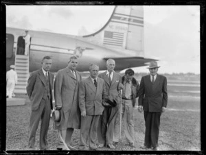 An unidentified portrait of PAA's 5th Survey Group in front of a PAA passenger plane, Whenuapai Airfield, Auckland