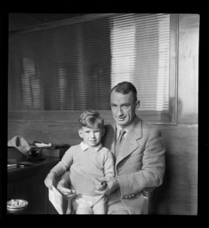 Portrait of K B Robinson, Instructor Auckland Aero Club with son, Whites Aviation Office, Auckland