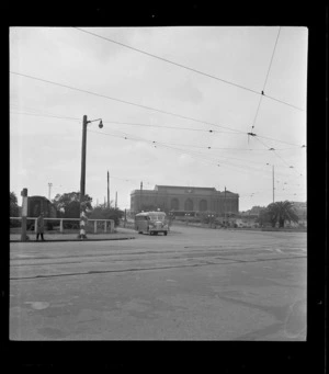 View of Johnston's Airways Transport Kiwi 2 bus leaving Auckland Railway Station for Mangere Airfield