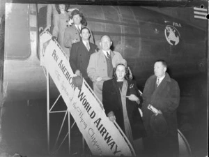 Unidentified passengers disembark a Pan American Airways Mandarin Clipper as it arrives at Whenuapai airfield, Auckland