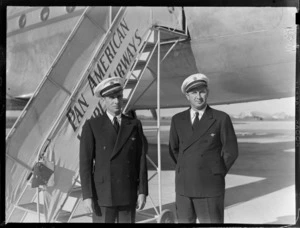 Pan American Airways pilots, Captain J E Anderson (left) and Captain S T Bancroft, next to a Pan American Airways Clipper aircraft, Whenuapai airfield, Auckland