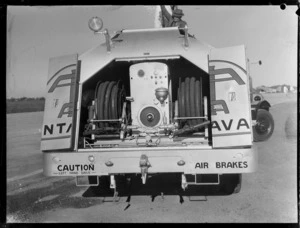 Rear view of a Vacuum Oil 'Intrava' trailer, Whenuapai airfield, Auckland, showing two hose reels