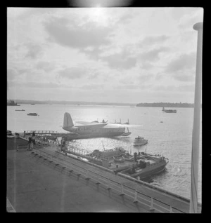 View of the Sutherland flying boat ZK-AMC and Mechanics Bay Base at sunset, Auckland City