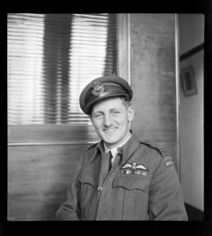 Portrait of Flight Lieutenant Lloyd Hunter in uniform, Whites Aviation Office, Auckland