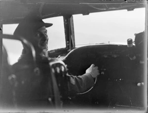 Portrait of Wing Commander A A N Brechon piloting a Pan American Airways Clipper Class Cathay DC4 Good Will Flight passenger plane, Whenuapai Airfield, Auckland
