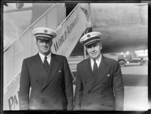 Portrait of Captains (L to R) B Lein and H Beyer in front a Pan American Airways Clipper Class Cathay DC4 passenger plane, Whenuapai Airfield, Auckland