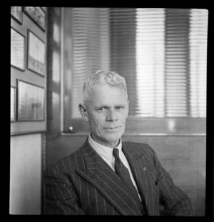 Portrait of Ernie West of Middle District Aero Club, at Whites Aviation Office, Auckland