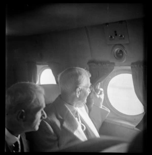 Portrait of Edmond Anderson and an unidentified man on a Pan American Airways Clipper Class Kathay DC4 passenger plane Good Will Flight, Whenuapai Airfield, Auckland