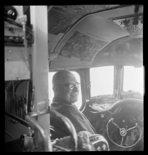 Portrait of J A C Allum, Mayor of Auckland, in the cockpit of a Pan American Airways Clipper Class Cathay DC4 Good Will Flight, Whenuapai Airfield, Auckland