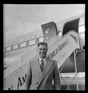 Portrait of Fred de Malmarche of Charles Harris Advertising disembarking from a Pan American Airways Clipper Class Cathay DC4 passenger plane Good Will Flight, Whenuapai Airfield, Auckland