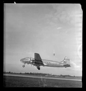 View of a Pan American Airways Clipper Class Cathay DC4 Good Will Flight passenger plane taking off from Whenuapai Airfield, Auckland