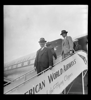Mr Sidney Holland and an unidentified man, disembarking from a Pan American World Airways Clipper flying boat, RNZAF Station, Whenuapai, Auckland
