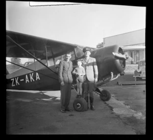 Les Rundle, Leo White and Ross White, standing alongside monoplane ZK-AKA, Mangere, Auckland