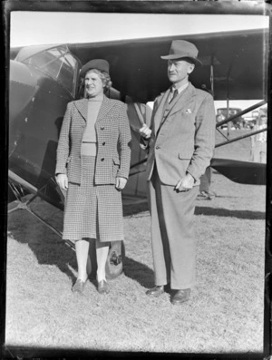 Mr HT Morton, with his sister, standing beside an aircraft, Mangere, Auckland