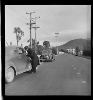 An unidentified traffic inspector [issuing a ticket to a motorist?], Rotorua