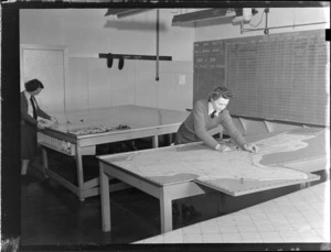 Flying Control Room, Mechanics Bay, Auckland, showing two unidentified women working with maps and charts