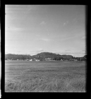 View of across an airfield to plane hangars and buildings beyond, Rotorua Aerodrome, Bay of Plenty