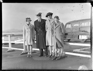 Portrait of Captain A V Jury of Tasman Empire Airways (TEA), in uniform with his family, [Auckland City waterfront?]