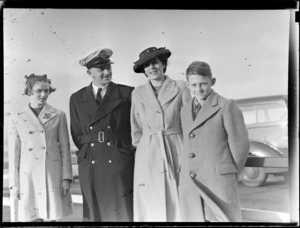 Portrait of Captain A V Jury of Tasman Empire Airways (TEA), in uniform with his family, [Auckland City waterfront?]