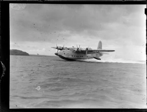 View of Tasman ZK-AME flying boat landing on Mechanic's Bay, Auckland Harbour