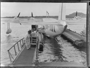 Tasman Empire Airways, Aotearoa aircraft (flying boat) in dock, includes harbour, dock and airport workers
