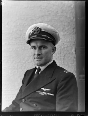 Portrait of Junior Captain I C Patterson of TEAL in uniform, in front of an unknown building, [Auckland?]