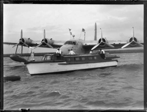 Front view of TEAL Short Tasman Flying Boat 'Australia' with launch and unidentified crew, Mechanic's Bay, Auckland Harbour