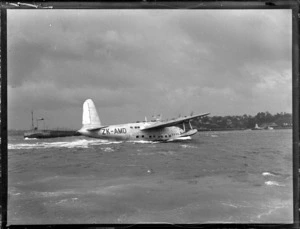 View of the arrival of TEAL Short Tasman Flying Boat ZK-AMD 'Australia' on Auckland Harbour, Mechanic's Bay, Auckland City