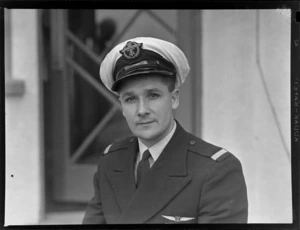 Portrait of Second Officer E A M Tredrea of TEAL in uniform outside an unidentified building, [Auckland?]