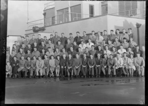 Group portrait of unidentified TEAL Engineering Staff outside a building at Mechanic's Bay, Auckland City