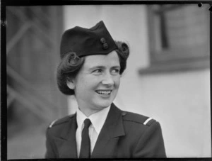 Portrait of Miss B P Morton TEAL Stewardess in uniform outside an unidentified building, [Auckland?]