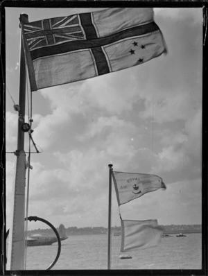 View of a TEAL flag and a Royal Air Mail flag flying on the TEAL Short Empire Flying Boat 'Awarua', Mechanic's Bay, Auckland Harbour