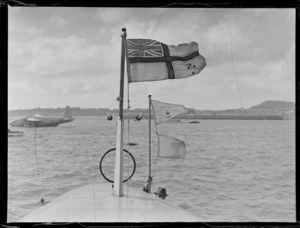 View of a TEAL home flag and a Royal Air Mail flag flying on top of the TEAL Short Empire Flying Boat 'Awarua', Mechanic's Bay, Auckland Harbour