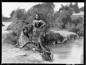 Unidentified Maori women wearing traditional dress (piupiu, korowai cloak and bodice with taniko design), Rotorua