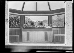 View of Franz Josef Glacier through the window of St James Anglican Church, Waiho, showing the altar, cross and candlesticks