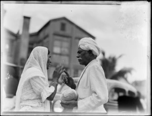 An unidentified man and woman at an outdoor market, Suva, Fiji