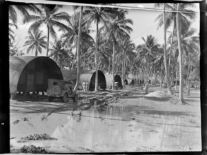RNZAF (Royal New Zealand Air Force) camp, showing corrugated-iron huts among palm trees, Vanuatu