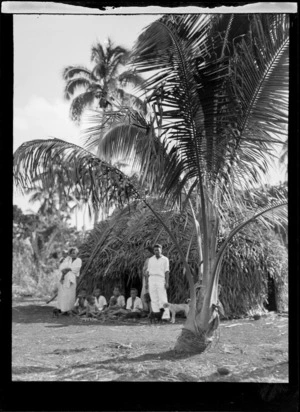 Portrait of a Tongan family in front of their hut, Tonga