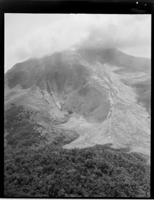 Close-up view of Mount Bagana erupting, with mud slides down the mountain side and through the bush, Bougainville Island, North Solomon Island group