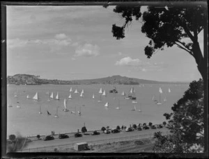 View of an Auckland Harbour yacht race from Tamaki Drive with spectators looking on, with North Head and Rangitoto Island beyond, Auckland City