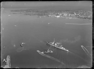 View of the arrival of the Leander Class Cruiser HMS Achilles to Devonport Naval Base, with Auckland City beyond