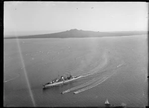View of the arrival of Leander Class Cruiser HMS Achilles to Auckland Harbour, with Rangitoto Island beyond