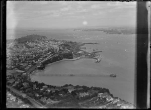 View of the Naval Base at Devonport with a yacht race on Auckland Harbour beyond