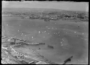 View of a yacht race on Auckland Harbour with Devonport in foreground and Auckland City beyond
