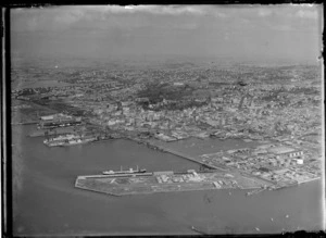 View of Freeman's Bay and Viaduct Harbour and the Ports of Auckland main wharves with docked ships to Auckland City beyond